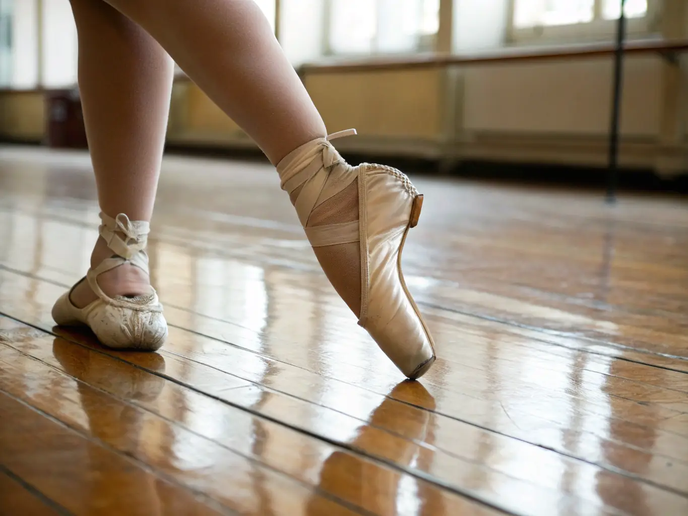 A close-up shot of dancers' feet moving gracefully during a Latin dance class, showcasing the energy and passion of the dance style. The focus is on the precision and rhythm of the steps.